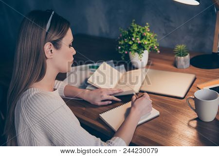 Portrait Of Concentrated Busy Girl Using Book Writing Down Notes In Notepad Having Pencil In Hands P
