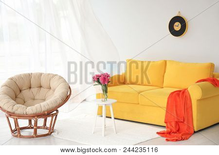 Elegant Living Room Interior With Comfortable Sofa And Papasan Chair
