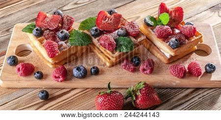 Belgian Waffles With Strawberry Jam, Fresh Strawberries, Raspberries, Blueberries And Chocolate Chip