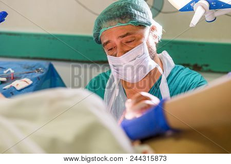 The Doctor Putting Stitches After Labor Assited By Nurse