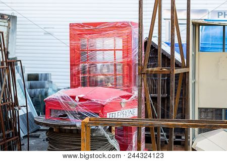 Old Shabby Replica Of London Red Telephone Box. Rusty Metal Structures, Old Broken Decoration Of Mov