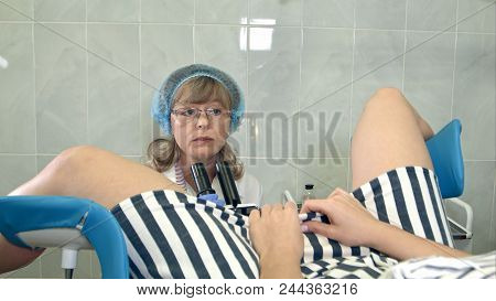 Gynecologist Examining A Patient With A Colposcope. Professional Shot In
