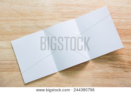 Blank Portrait Mock-up Paper. Brochure Magazine Isolated On Brown Wooden Table, Changeable Backgroun