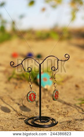 Earrings On The Stand On Sand Or Ground