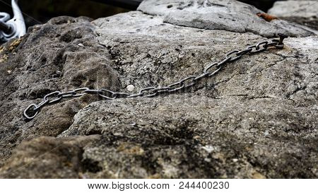 Chain Nailed Into The Rock With Rusty Nail