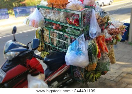 Traditional Asian Street Food In Bali - Motobike Is Hung With Packages With Different Snacks, Fast F