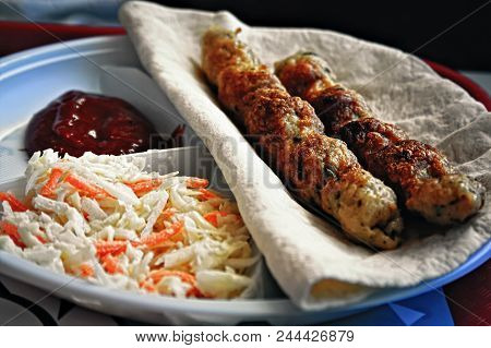Portion Of Lula-kebab On Wheat Pita With Ketchup And Salad