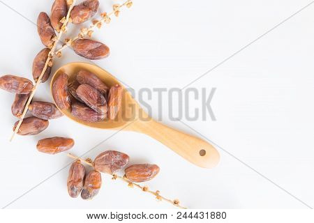Dates Fruit In Wooden Ladle On White Background,dried Date Palm Fruits Top View