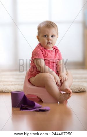 Funny Baby Girl Sitting On Chamberpot In Room