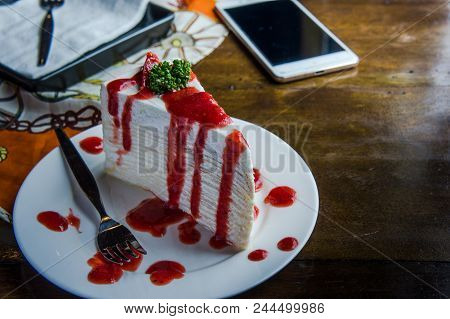 Strawberry Crape Cake On Wood Table In Coffee Shop , Dessert Tasy Cake