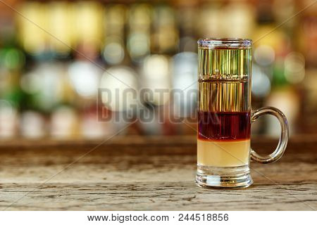 A Multi-layered Cocktail Of Three Layers Of Alcohol On The Bar In A Nightclub. Cocktail Thujone Stam