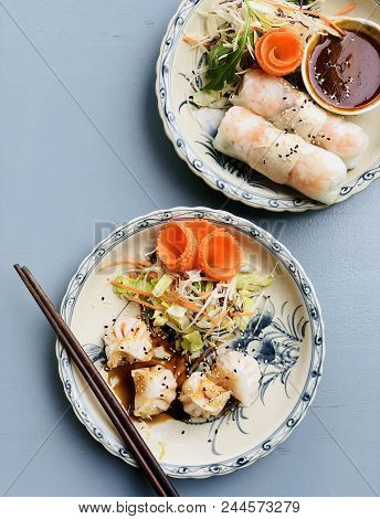 Asian Style Dinner. Flat-lay Of Steamed Dumplings Dim Sum And Summer Rice Paper Rolls With Shrimp An