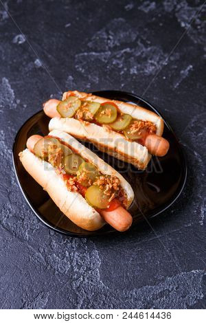 Photo Of Hotdogs On Black Plate At Table