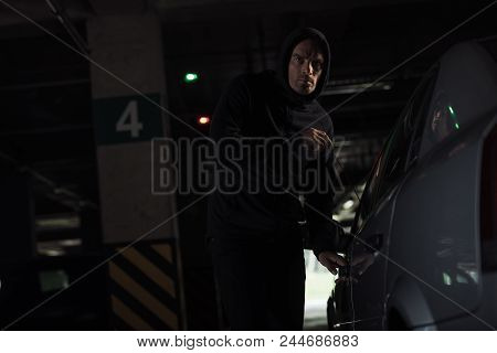 Serious Male Robber Intruding Car By Picklock