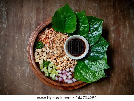 Leaf-wrapped Bite-size Appetizer. A Thai Snack Set Of Wild Betel Leaf Bush Leave With Ingredients Ch