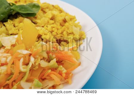 Baked Bulgar With Cauliflower And Vegetable Salad On A Blue