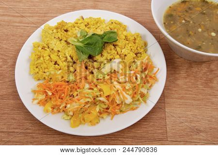 Baked Bulgar With Cauliflower And Vegetable Salad On A Table