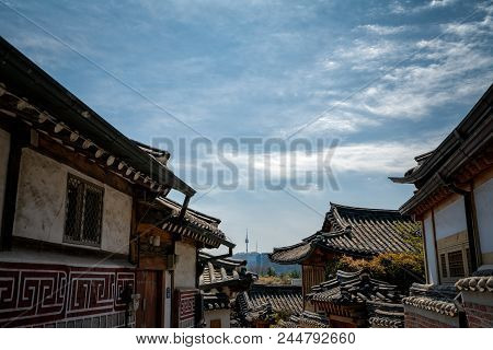 Traditional Korean Style Architecture In Bukchon Hanok Village With N Seoul Tower On Namsan Mountain