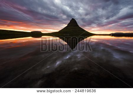Colorful sunrise on Kirkjufellsfoss waterfall. Amazing morning scene near Kirkjufell volkano, Iceland, Europe.
