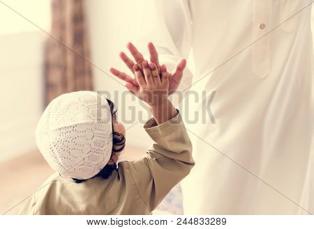 Muslim boy giving a high five