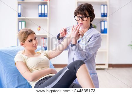 Doctor checking joint flexibility with goniometer