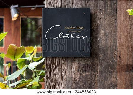 Black signage on a rustic wooden wall mockup