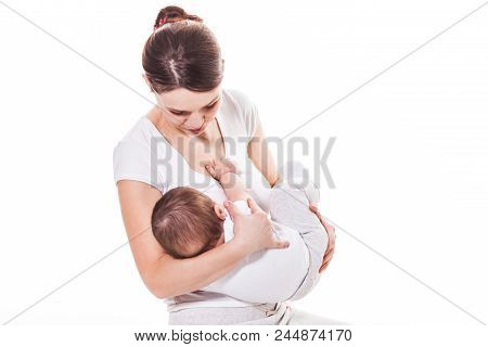 Mother Breastfeeds The Baby Isolated On White