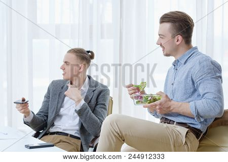 Relaxed Office Atmosphere. Communication And Comradery At Work. Business Men Talking At Lunch Break