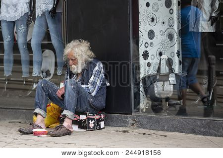Sofia, Bulgaria - 7 May, 2018: Homeless Old Man With Long White Beard Begs For Money In Front Of Clo