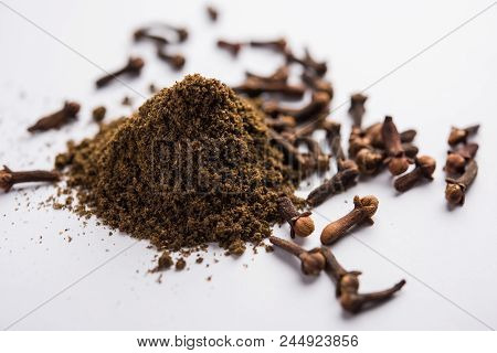 Whole Cloves Or Laung Or Lavang With Powder In A Bowl Isolated On White. Whole Cloves. Selective Foc