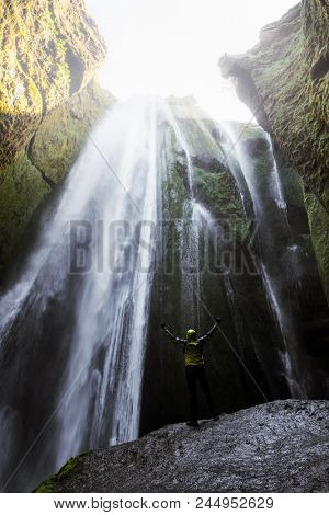 Man in the cave near the Gljufrabui waterfall, Iceland, Europe