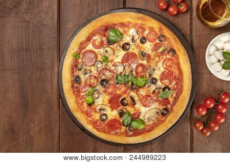 Overhead Photo Of Pepperoni Pizza With Glass Of White Wine, Cherry Tomatoes And Mozzarellini Cheese,