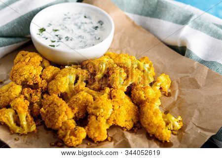 Lose Up Cauliflower In Batter With Sour Cream Sauce On Kraft Paper