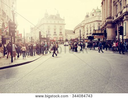 Piccadilly Circus, London, UK: Aug 2014: Crowds of people in the famous Piccadilly Circus area of London