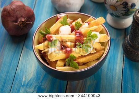 Canadian poutine, fried potato chips with cheese and gravy or sauce