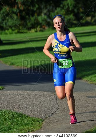 St Neots , Cambridgeshire, England - September 01, 2019: Young Female Triathlon Competitor In Runnin
