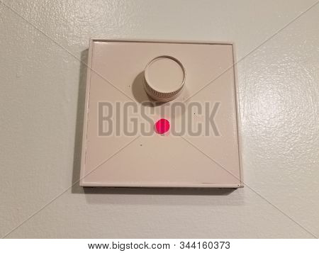 White Dimmer On Wall With Red Light