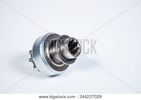 New Spare Parts - Starter Gear Drive For Motor Starter On A Gray Background. Classic Gear Transmissi