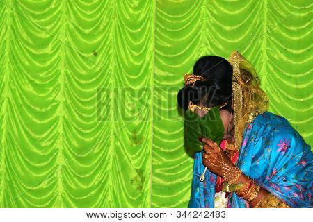A Beautiful Happy Indian Bride Holding Betel Leaf , Bengali Bride In Traditional Wedding Saree. Copy