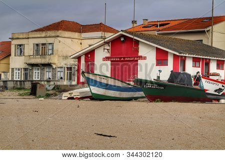 Miramar, Porto, Portugal- January 8, 2020: Colorful Fishing Boats Stranded On Aguda Beach And Little