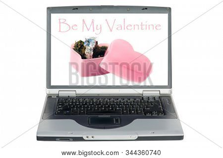 Laptop Computer. Marijuana in a pink heart shaped box with a diamond engagement or wedding ring. Valentines Day Surprise Gift. Isolated on white. Room for text. Clipping Path. Be my Valentine. 