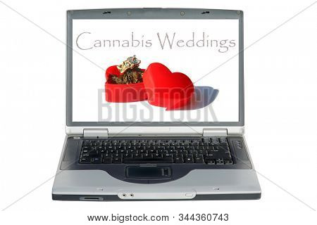 Laptop Computer. Marijuana or Cannabis in a Red Heart shaped box with a diamond engagement or wedding ring. Wedding Day Surprise Gift. Isolated on white. Room for text. Clipping Path. Be my Wife. 
