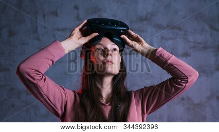 Short Break. A Delighted Girl Holds Virtual Reality Glasses On Her Forehead. She Takes Off, Opens He