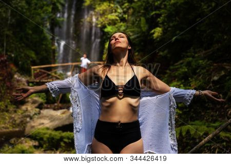Woman near Labuhan Kebo Waterfall located in Munduk, Bali