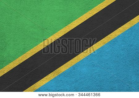 Tanzania Flag Depicted In Bright Paint Colors On Old Relief Plastering Wall. Textured Banner On Roug