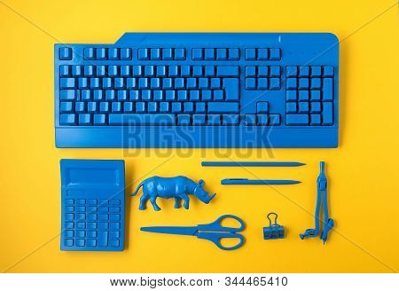 Office Suplies Painted In Classic Blue Color Over Yelow Background. Study, Education, Creative Offic