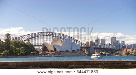 Sydney Opera House And Harbour Bridge With Boat And Buildings In Background On The Sunny Clear Sky D