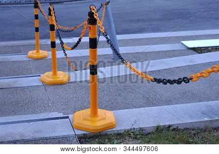 Barrier Of Plastic Poles And Chain Keeping Safe Pedestrians On A Concrete Staircase Without Banniste