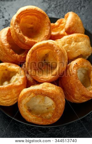 Traditional English Yorkshire Pudding Side Dish On Black Plate And Background
