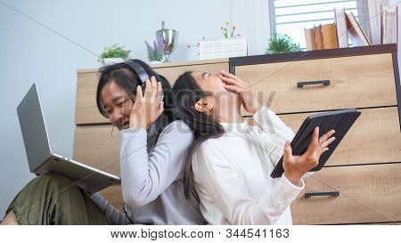 Happy Asian Entrepreneur Students Laughing Studying E-learning Online With Headphones Tablet And Lap